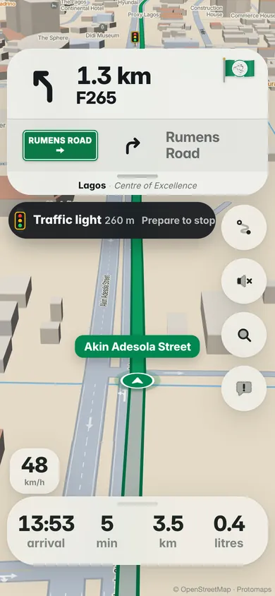 Driving up Akin Adesola Street: Traffic light in 260 m, prepare to stop, under the next turn and its Rumens Road sign