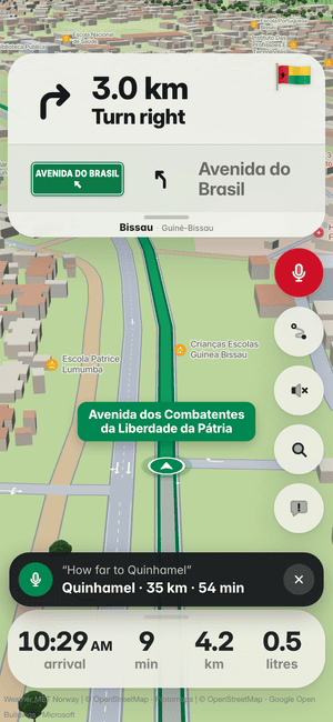 Driving in Bissau, asking by voice “How far to Quinhamel”; the answer: Quinhamel · 35 km · 54 min