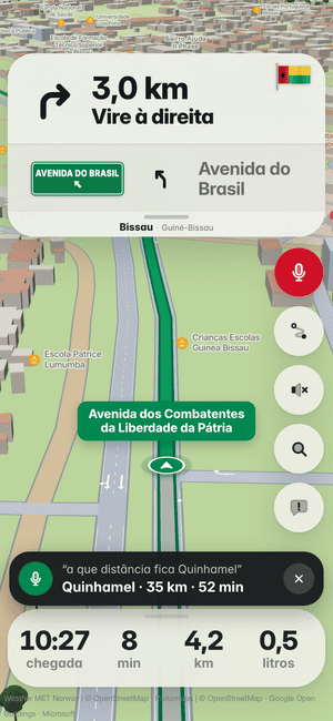 A conduzir em Bissau, pergunta em voz alta “a que distância fica Quinhamel”; a resposta: Quinhamel · 35 km · 52 min