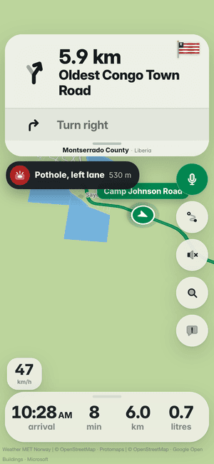 Driving in Monrovia: the “Pothole, left lane 530 m” banner, a pothole other drivers found ahead