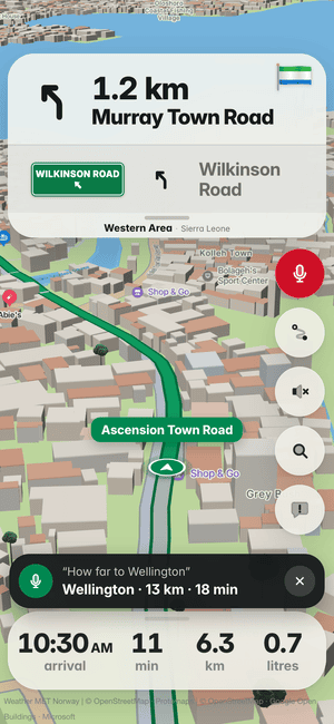 Driving in Freetown, asking by voice “How far to Wellington”; the answer: Wellington · 13 km · 18 min